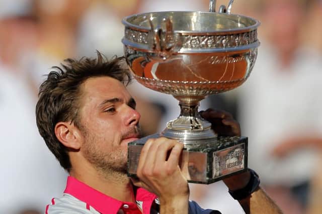 Switzerland's Stan Wawrinka lifts the cup after defeating Serbia's Novak Djokovic. Picture: AP