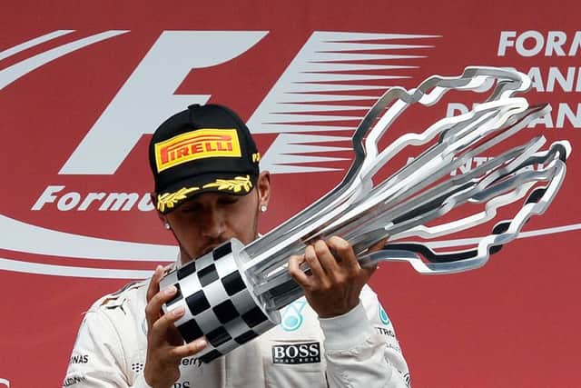 Lewis Hamilton kisses the trophy on the podium at the Circuit Gilles Villeneuve in Montreal. Picture: AFP/Getty Images