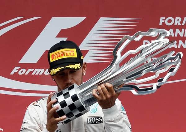 Lewis Hamilton kisses the trophy on the podium at the Circuit Gilles Villeneuve in Montreal. Picture: AFP/Getty Images