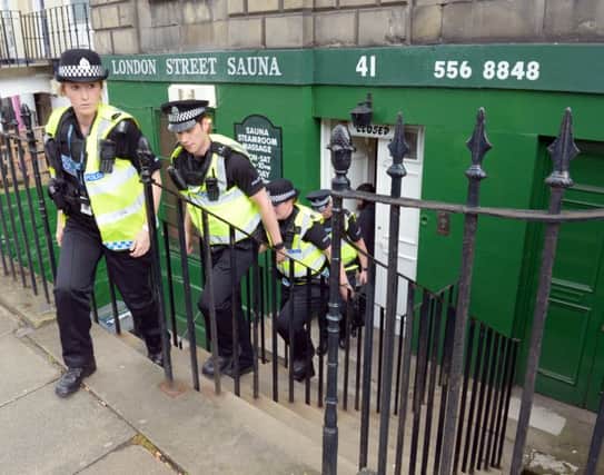 Police officers raid a sauna in Edinburgh. Picture: TSPL