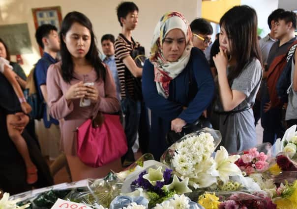 Flowers at the school that lost six pupils and a teacher. Picture: AFP