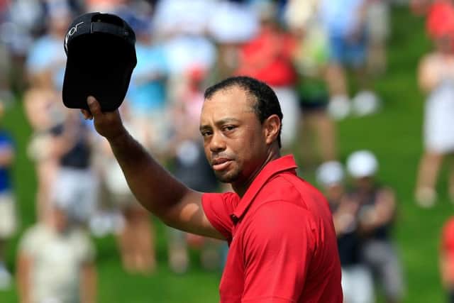 A forlorn Tiger Woods acknowledges the crowd on the 18th hole after his disastrous final round at The Memorial. Picture: Getty