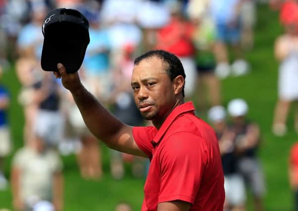 A forlorn Tiger Woods acknowledges the crowd on the 18th hole after his disastrous final round at The Memorial. Picture: Getty