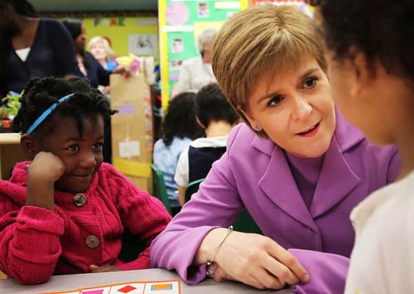 First Minister Nicola Sturgeon sits with students while visiting a school in Brooklyn. Picture: Getty Images