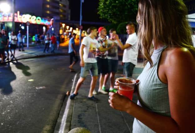 Partying continues on the streets of Magaluf in the early hours yesterday as Jenna McAlpine recovers in hospital. Picture: AP