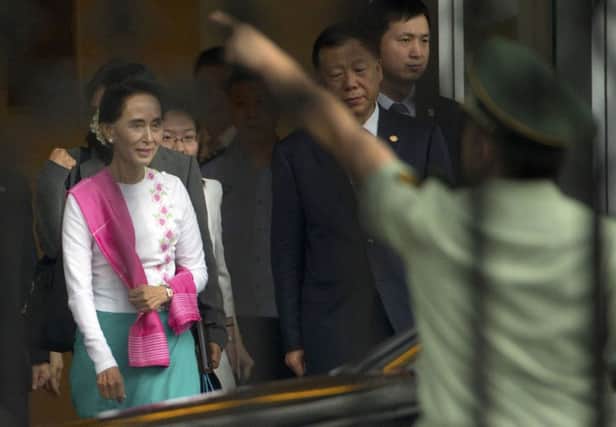 Suu Kyi arrives at Beijing international airport yesterday. Picture: AP
