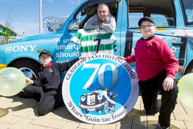 Tom Boyd joins Damien Wright (9) and Daniel Sweeney (12) to promote the Glasgow Taxis Outing. Picture: SNS