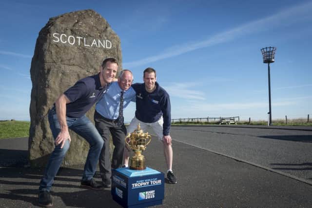 Roy Laidlaw, centre, with Will Greenwood, left, and Chris Paterson welcome the World Cup trophy. Picture: Rob Gray