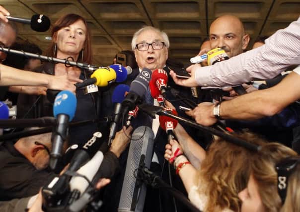 Henri Leclerc, right, lawyer of former International Monetary Fund chief Dominique Strauss-Kahn, answers journalists at a Lille courthouse, northern France. Picture: AP