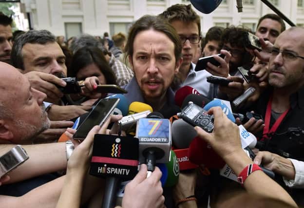 Podemos leader Pablo Iglesias is mobbed by the media in Madrid. Picture: AFP/Getty