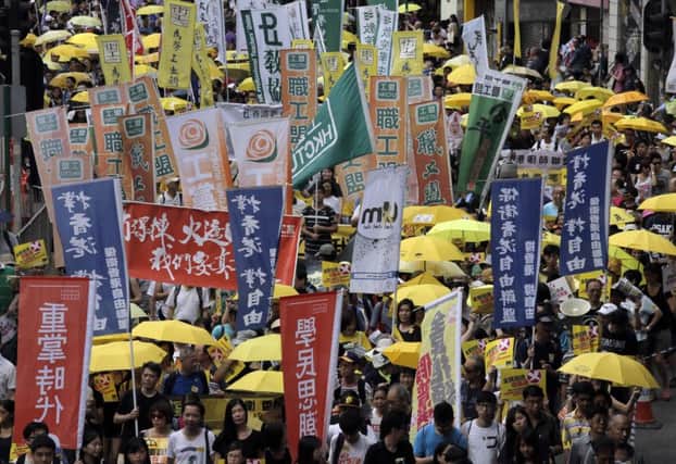 Thousands of marchers march through the streets of Hong Kong in protest at electoral reforms. Picture: AP