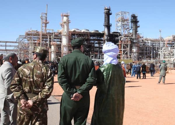 Algerian soldiers and officials at the gas plant in Ain Amenas which was the subject of a 2013 attack. Picture: AP