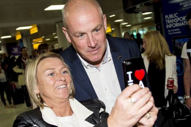 New Rangers manager Mark Warburton chats with a fan after arriving at Glasgow Airport. Picture: SNS