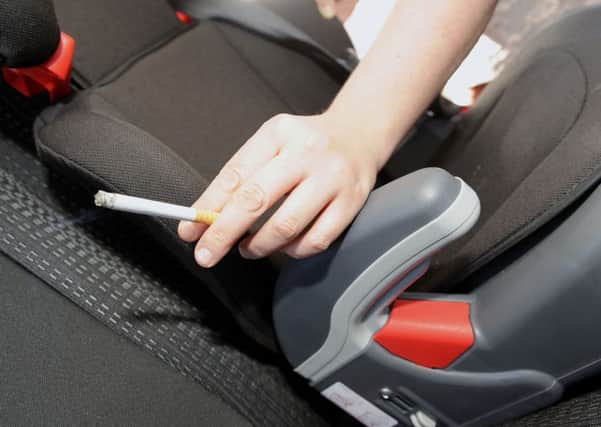 Enforcing a ban on smoking in cars while children are present would be challenging for police, it has been claimed. Picture: Gary Hutchison
