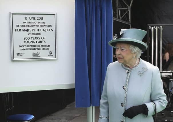 The Queen unveils a plaque at Runnymede during the commemoration ceremony. Picture: AP