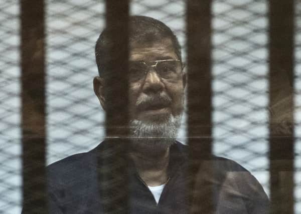 Egypt's ousted Islamist president Mohamed Morsi stands behind the bars during his trial in Cairo on June 16, 2015. Picture: AFP/Getty Images