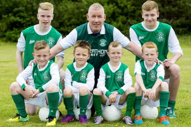 Former Hibs star Keith Wright with players of Edina Hibs as the boys club joined the Hibernian Community Football Club. Picture: SNS