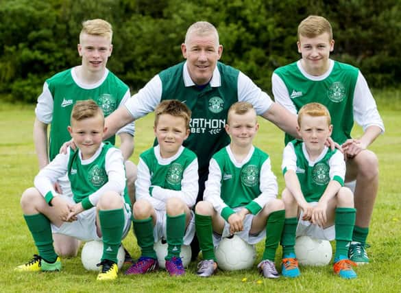 Former Hibs star Keith Wright with players of Edina Hibs as the boys club joined the Hibernian Community Football Club. Picture: SNS