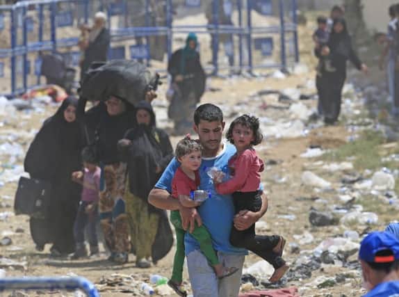 Syrian refugees flee fighting in Syria between Kurdish fighters and Islamic State militants. Picture: AP