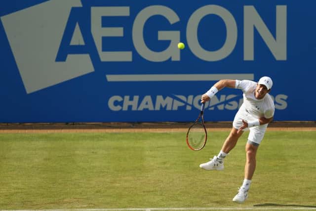 Andy Murray serves to YenHsun Lu during his firstround victory at Queens yesterday. Picture: Getty