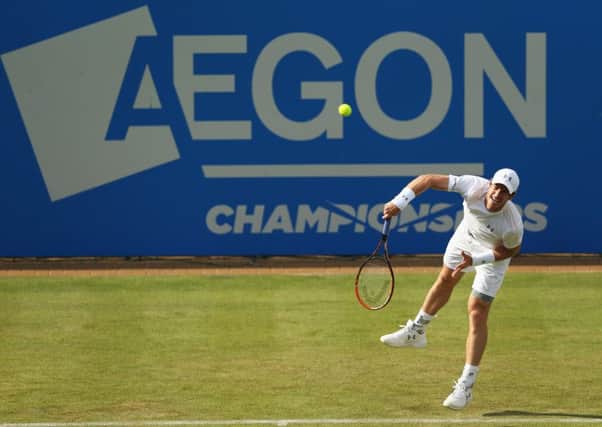 Andy Murray serves to YenHsun Lu during his firstround victory at Queens yesterday. Picture: Getty