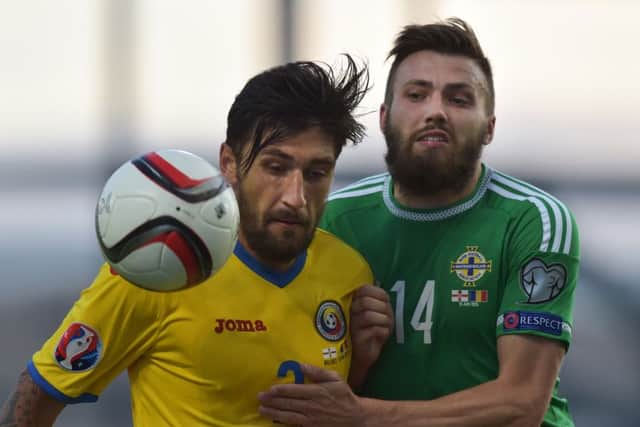 Stuart Dallas vies for the ball with Paul Papp during the Euro 2016 qualifier between Northern Ireland and Romania. Picture: Getty