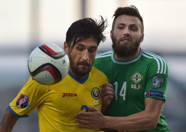 Stuart Dallas vies for the ball with Paul Papp during the Euro 2016 qualifier between Northern Ireland and Romania. Picture: Getty