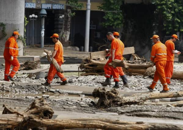 Workers clean an area around the flooded zoo in Tbilisi. Picture: AP