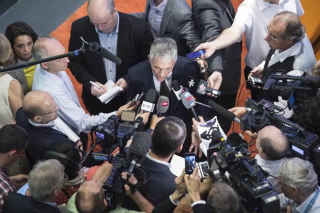 Swiss attorney-general Michael Lauber is mobbed by the media as he gives an update on his investigation. Picture: AP