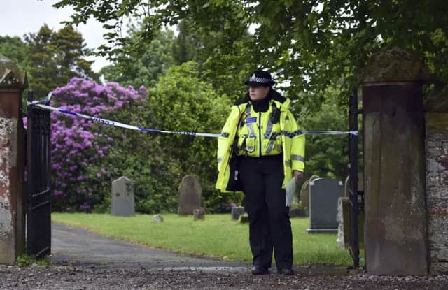 Police stand guard at the scene yesterday, which is near the victims home. Picture: PA