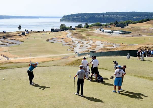 Puget Sound provides a stunning backdrop as defending champion Martin Kaymer hits a tee shot. Picture: Getty