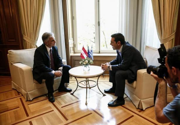 Greeces prime minister Alexis Tsipras, right, speaks to Austrian chancellor Werner Faymann yesterday. Picture: AP