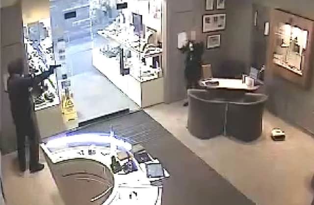 CCTV from the shop shows Matthew Ferry threatening a member of staff with a handgun