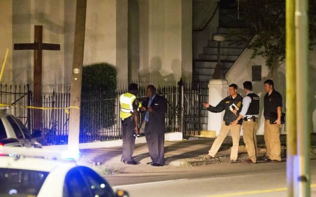 Police stand outside the Emanuel AME Church following a shooting . Picture: AP