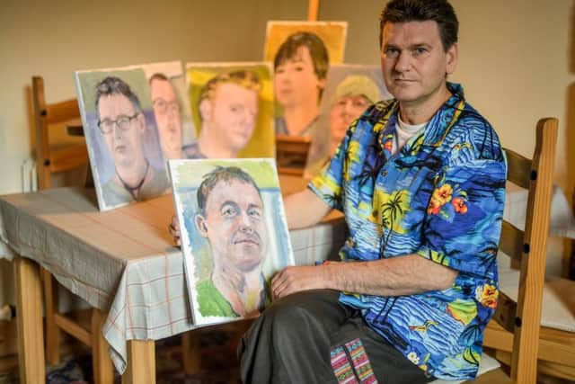 Brian Keeley, 52, is pictured, with the portraits of some of the staff that treated him that he painted. Picture: Contributed
