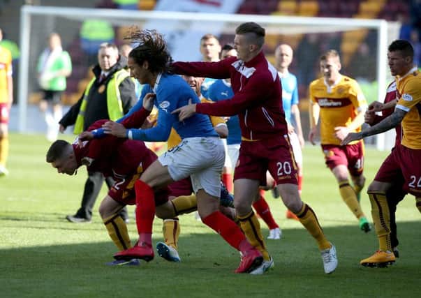 Rangers player Bilel Mohsni clashes with Motherwell players. Picture: PA