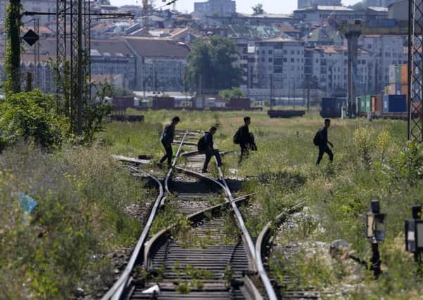 Migrants pictured in Belgrade, Serbias capital  they could now face a security fence to stop their progress into Hungary. Picture: AP