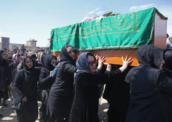 Womens rights activists carry 27-year-old Farkhundas coffin after she was punched, kicked, beaten and crushed to death. Picture: AP