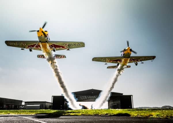 The two planes exit the hangar after successfully flying through it side-by-side. Picture: PA