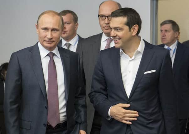 Greek prime minister Alexis Tsipras, right, meets Russias Vladimir Putin yesterday to discuss the crisis. Picture: AP