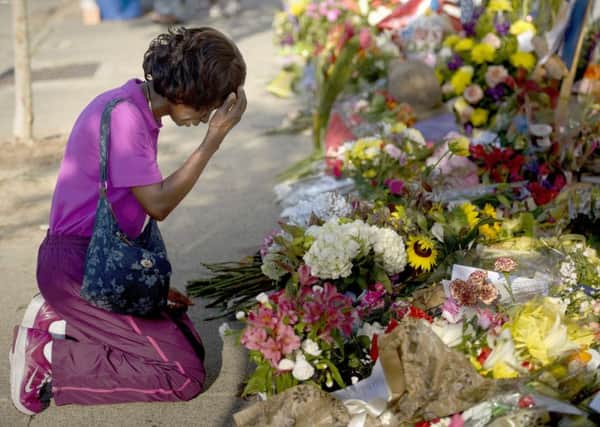 Patricia Bailey says a prayer at a memorial to the dead outside the Emanuel AME Church in Charleston, South Carolina. Picture: Getty
