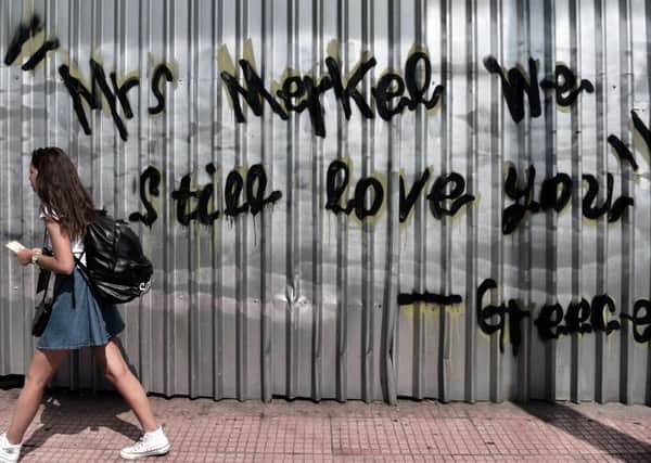 Graffiti in central Athens sends Angela Merkel a message yesterday. Picture: Getty