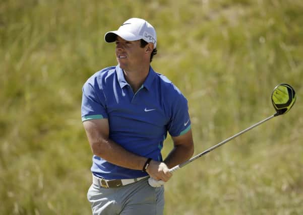 Rory McIlroy watches his tee shot at the 7th hole yesterday.  Photograph: Getty