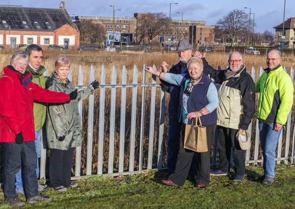 Residents and councillors by a piece of derelict land they wish Edinburgh City Council to make a compulsory purchase order for. Picture: Malcolm McCurrach