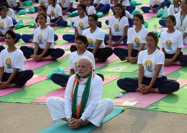 Indian Prime Minister Narendra Modi (C) participates in a mass yoga session along with other Indian yoga practitioners. Picture: AP
