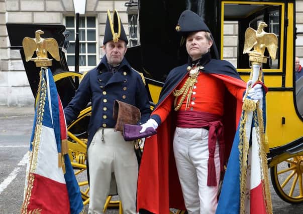 Actors dressed as Commander James White, left, and Major Henry Percy with replicas of the French imperial Eagles. Picture: PA