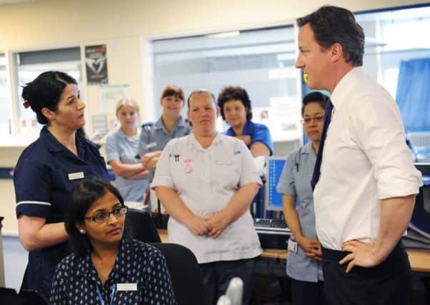 David Cameron visits a London hospital last month. He is under intense pressure to cut immigration. Picture: Getty