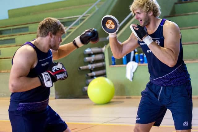 Brothers Ritchie, right, and Jonny Gray focus on some pad work in a crossover skills training session at the Scotland rugby squads base in France. Picture: SNS/SRU
