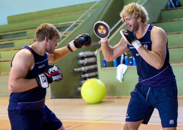 Brothers Ritchie, right, and Jonny Gray focus on some pad work in a crossover skills training session at the Scotland rugby squads base in France. Picture: SNS/SRU