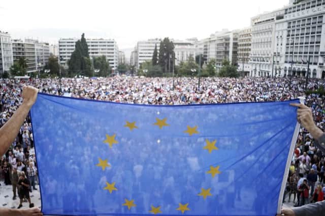 Pro-European Union protesters take part in a rally in front of the parliament in Athens, Greece. Picture: Getty